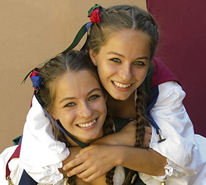 Photo of twin young women dressed in renaissance clothing.